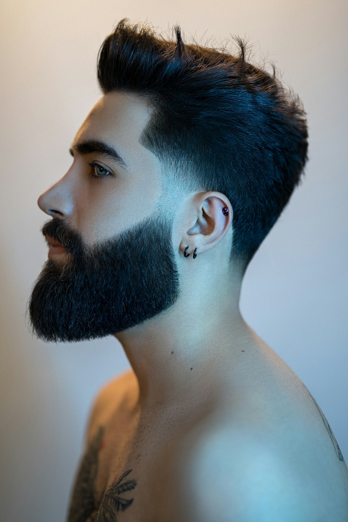 Profile of a man with a full, neatly shaped dark beard, the kind of beard balm users aim for